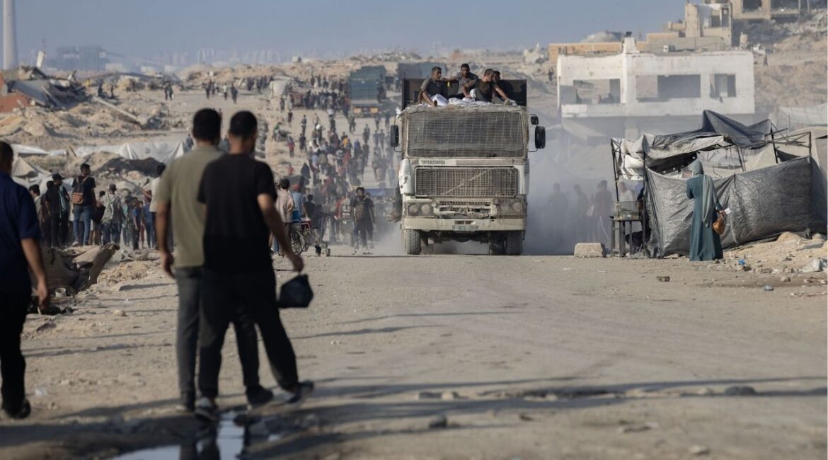 Palestinians climb onto a truck carrying aid northwest of Gaza City, Aug. 14, 2025. More than three dozen humanitarian groups will have their authorizations to operate in the Gaza Strip suspended on Jan. 1 and will have to clear out by March after failing to comply with new registration rules, Israel’s Ministry of Diaspora Affairs said on Tuesday. (Saher Alghorra/The New York Times)