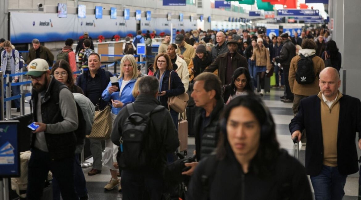 Passengers carry their luggage as they wait to board flights for the Thanksgiving holidays, at Chicago O'Hare International Airport in Chicago, Illinois, U.S., November 26, 2025. (Reuters/Jim Vondruska)