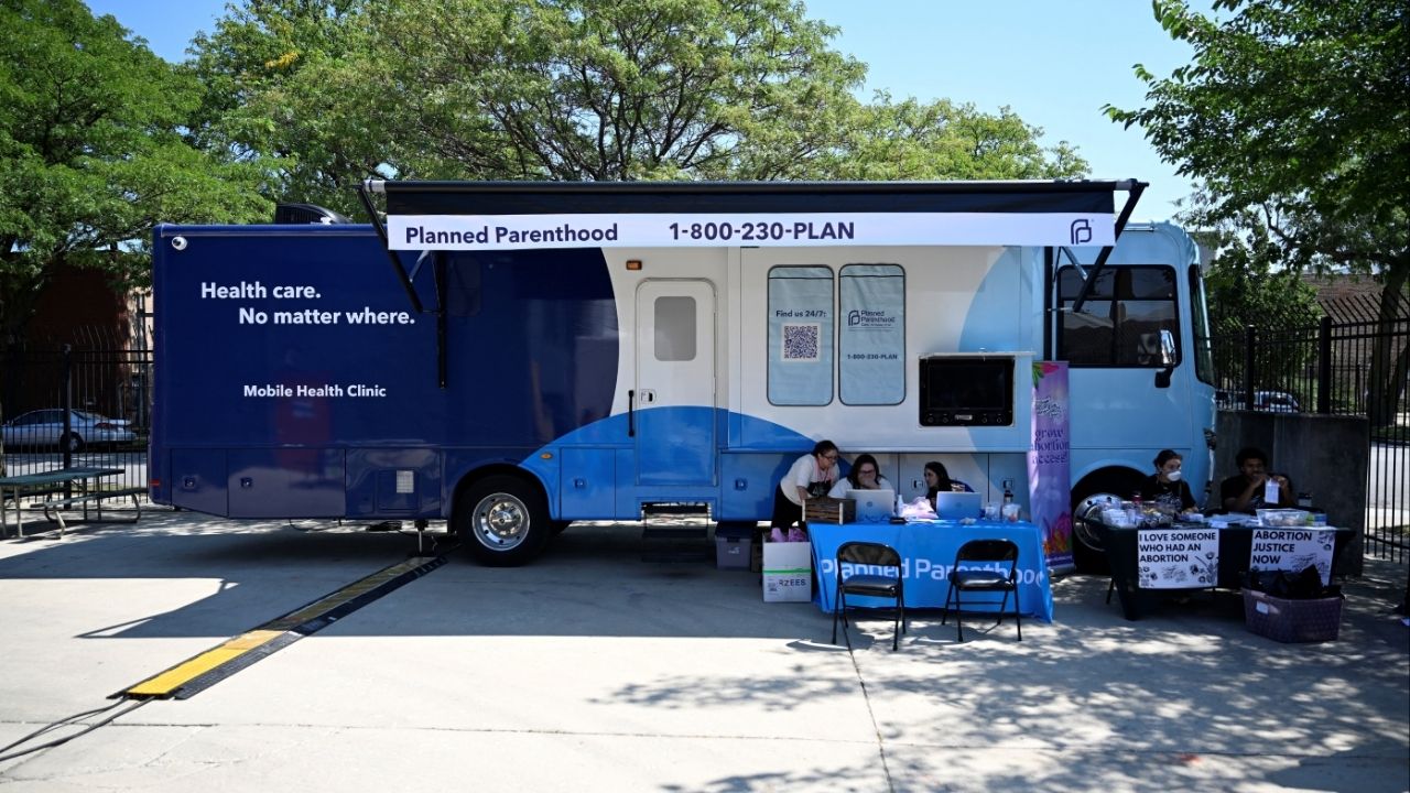 People check computers outside of a Planned Parenthood mobile clinic nearby the United Center in Chicago, Illinois, U.S. August 19, 2024 (Reuters/Vincent Alban)