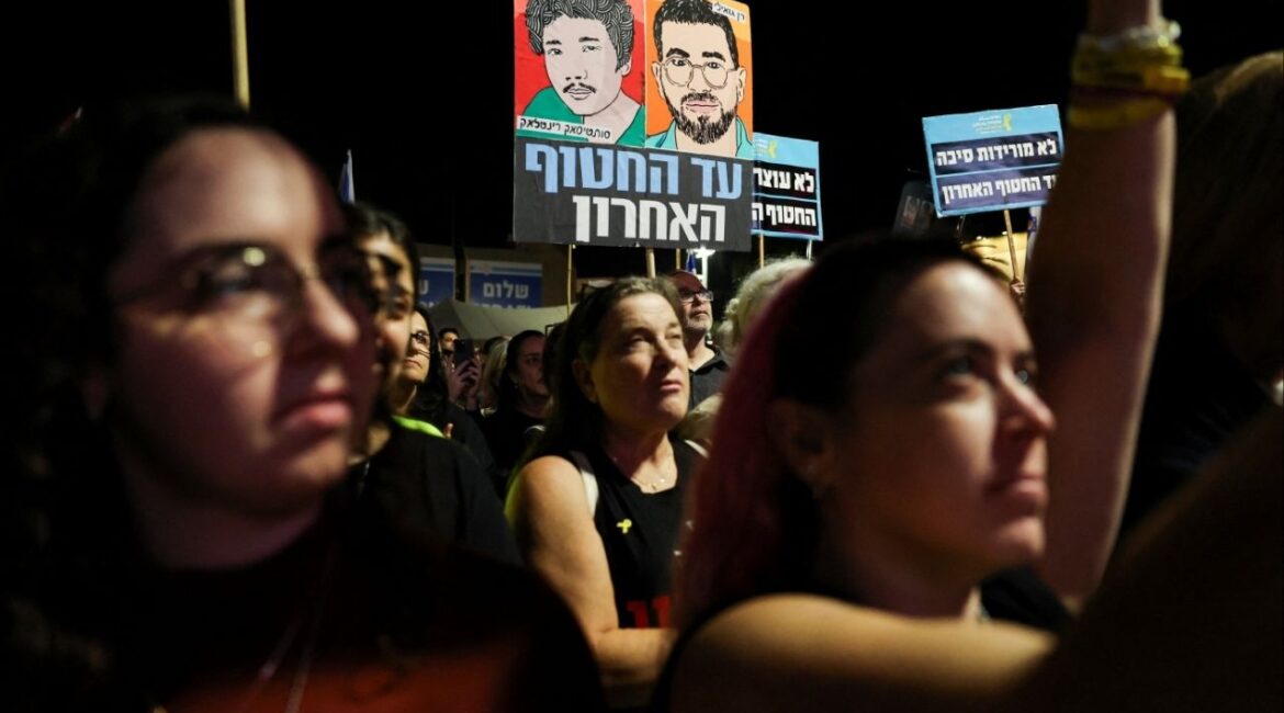 People hold images of dead hostages Ran Gvili and Sudthisak Rinthalak, whose bodies haven’t been returned yet, as Israelis attend a rally calling for the immediate return of the remains of all hostages held in Gaza, more than two years after the deadly October 7, 2023, attack on Israel by Hamas, at the Hostages Square in Tel Aviv, Israel, November 29, 2025. (Reuters/Nir Elias)