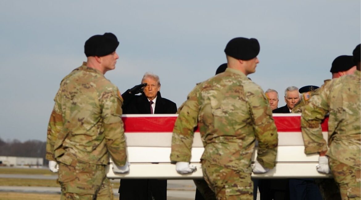 President Donald Trump salutes during a dignified transfer of remains service for two Iowa National Guard members who were killed in Syria, at Dover Air Force Base in Delaware, on Wednesday, Dec. 17, 2025. American fighter jets, attack helicopters and artillery salvos struck dozens of suspected Islamic State sites in a “massive attack” across central Syria on Friday night, according to a U.S. official speaking on condition of anonymity. (Tierney L. Cross/The New York Times)