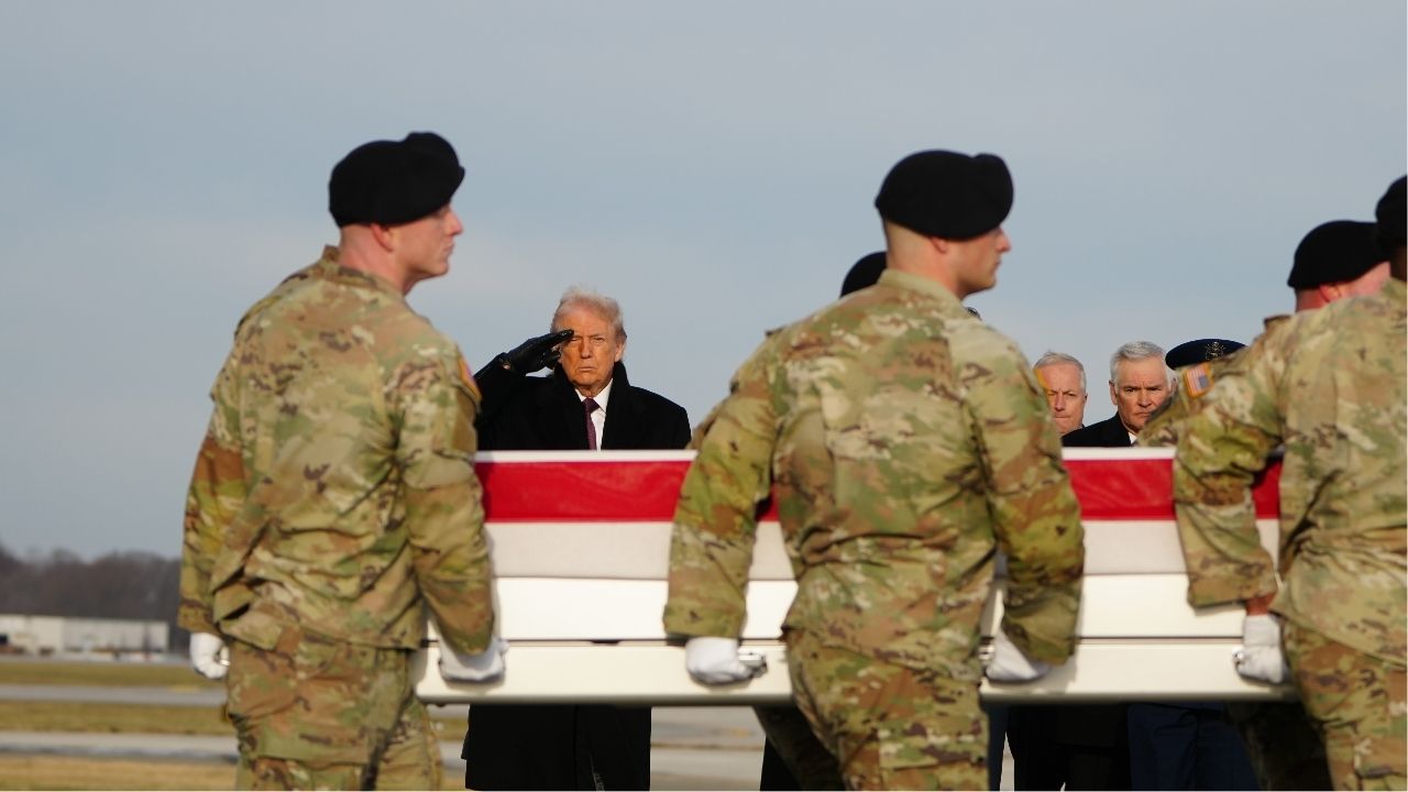 President Donald Trump salutes during a dignified transfer of remains service for two Iowa National Guard members who were killed in Syria, at Dover Air Force Base in Delaware, on Wednesday, Dec. 17, 2025. American fighter jets, attack helicopters and artillery salvos struck dozens of suspected Islamic State sites in a “massive attack” across central Syria on Friday night, according to a U.S. official speaking on condition of anonymity. (Tierney L. Cross/The New York Times)