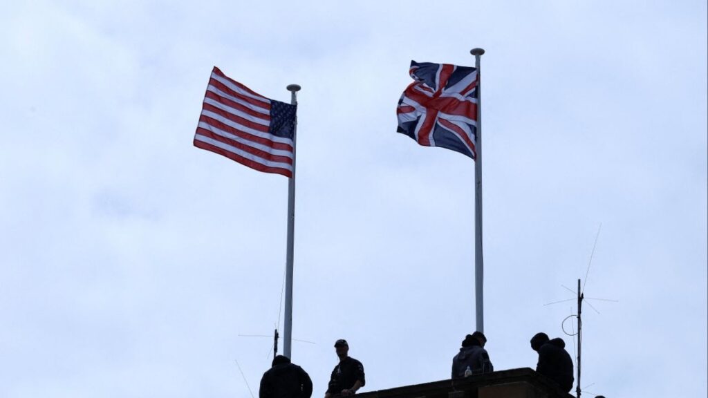 Security personnel stand guard, as a Union Jack and U.S. flag flutter on a roof, on the day of a meeting between U.S. President Donald Trump and British Prime Minister Keir Starmer, at Trump Turnberry golf course in Turnberry, Scotland, Britain, July 28, 2025. (Reuters/Evelyn Hockstein)