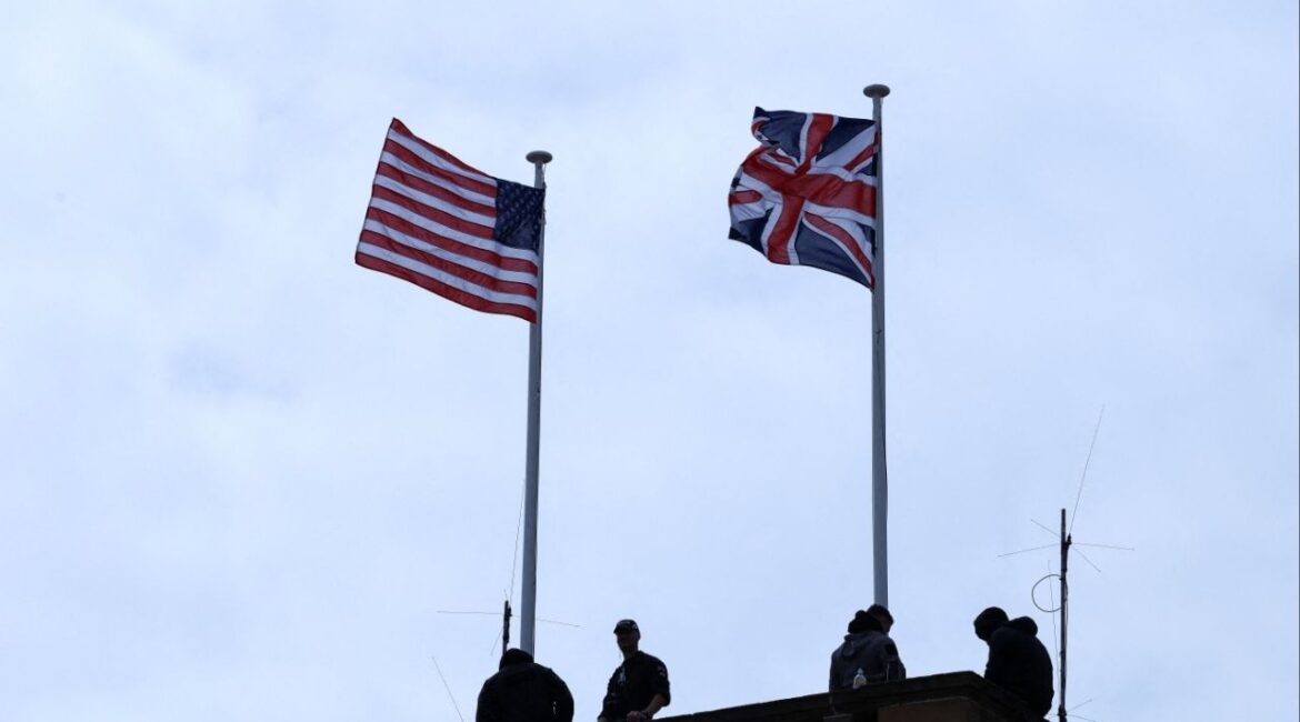 Security personnel stand guard, as a Union Jack and U.S. flag flutter on a roof, on the day of a meeting between U.S. President Donald Trump and British Prime Minister Keir Starmer, at Trump Turnberry golf course in Turnberry, Scotland, Britain, July 28, 2025. (Reuters/Evelyn Hockstein)