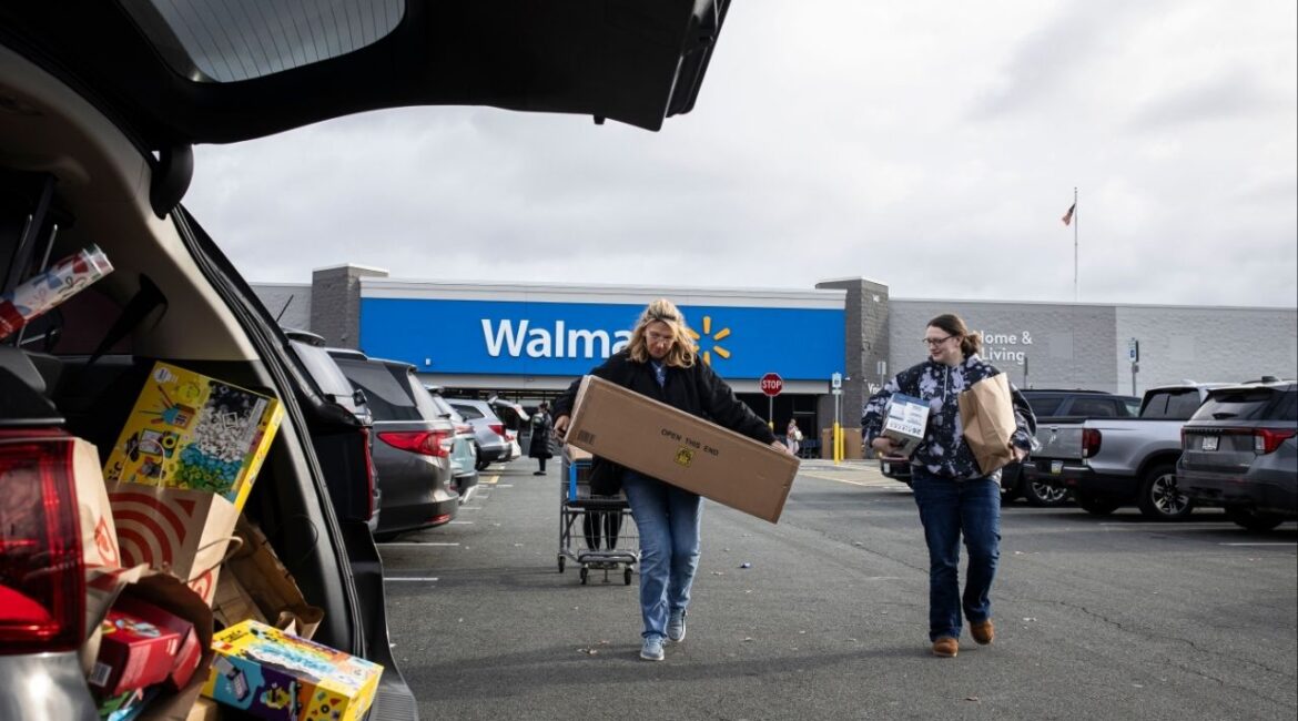 Shoppers outside a Walmart in Albany, N.Y. on Black Friday morning, Nov. 28, 2025. For most people, the tax cuts that President Donald Trump signed into law this summer have yet to materialize. But Walmart and many more of America’s largest companies have not had to wait. (Dave Sanders/The New York Times)