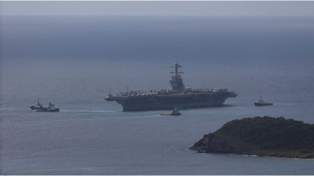 The U.S. Navy USS Gerald R. Ford aircraft carrier (CVN-78) is moved by tug boats near Saint Thomas, U.S. Virgin Islands, December 1, 2025. (Reuters/Marco Bello)