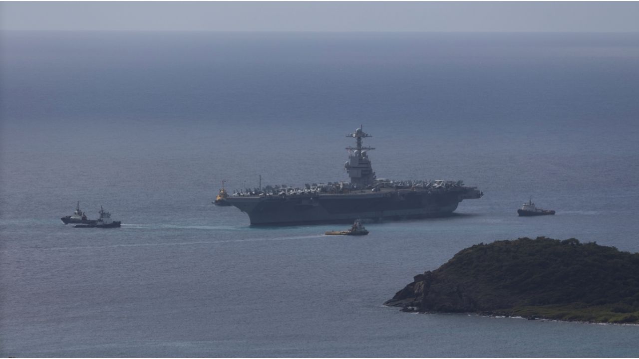 The U.S. Navy USS Gerald R. Ford aircraft carrier (CVN-78) is moved by tug boats near Saint Thomas, U.S. Virgin Islands, December 1, 2025. (Reuters/Marco Bello)