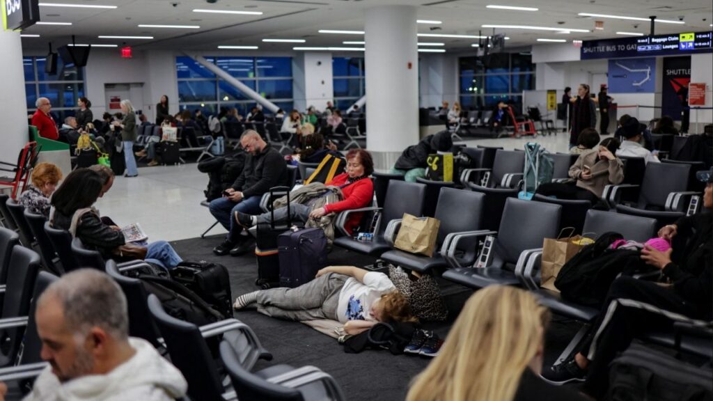 Travellers wait for a flight at John F. Kennedy (JFK) International Airport in New York City, U.S., November 18, 2025. (Reuters/Jeenah Moon)