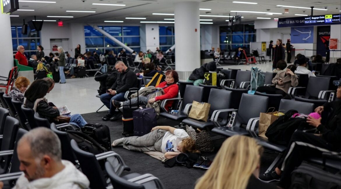 Travellers wait for a flight at John F. Kennedy (JFK) International Airport in New York City, U.S., November 18, 2025. (Reuters/Jeenah Moon)