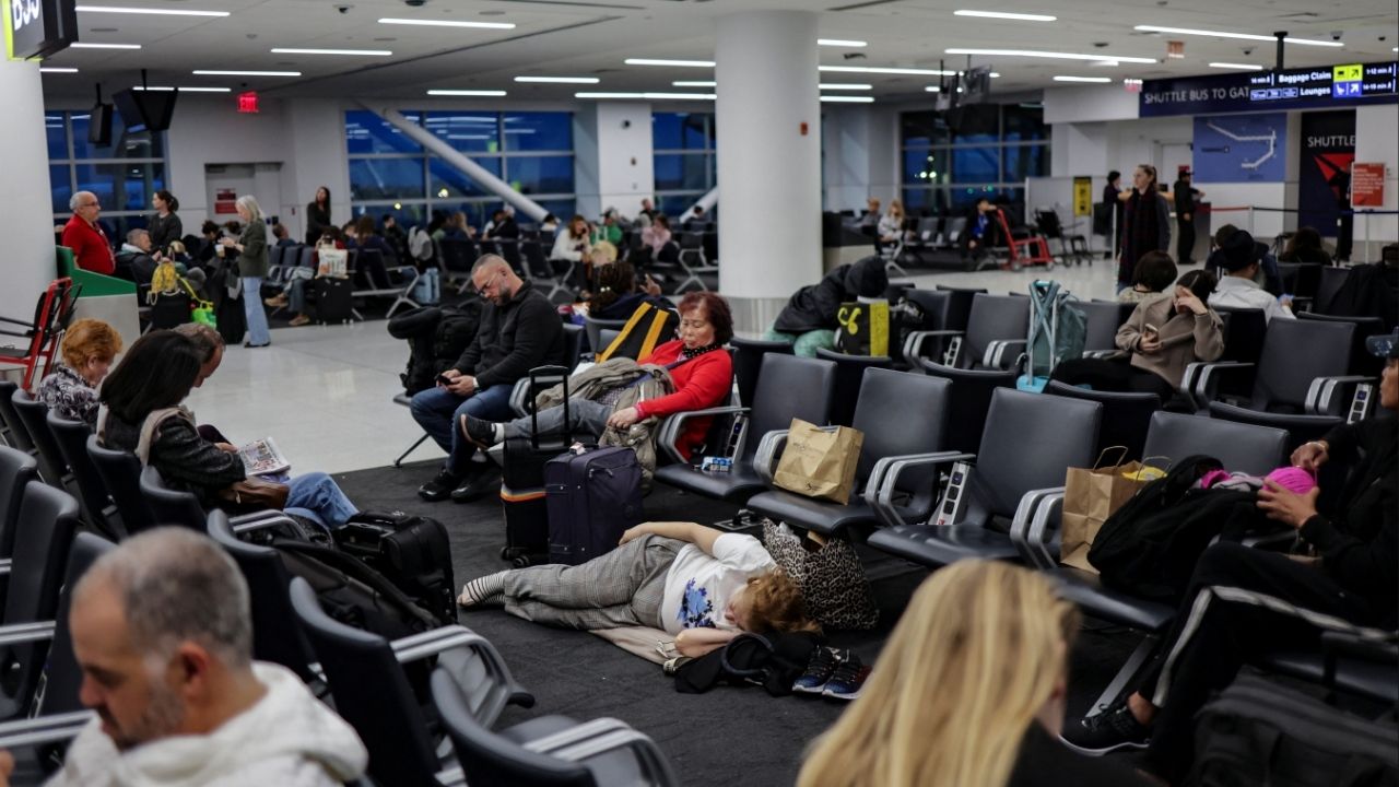 Travellers wait for a flight at John F. Kennedy (JFK) International Airport in New York City, U.S., November 18, 2025. (Reuters/Jeenah Moon)