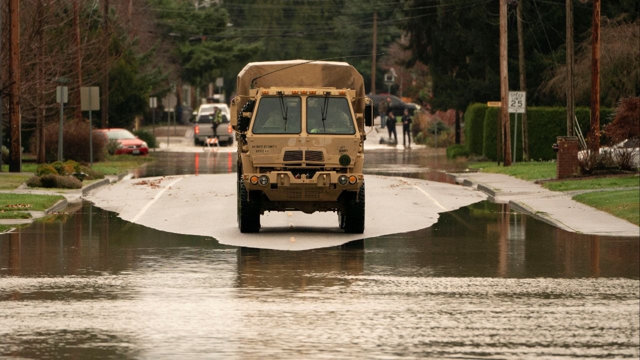 Washington National Guard personnel use a military vehicle to assist in search and rescue operations, as an atmospheric river brings rain and flooding to the Pacific Northwest, in Burlington, Washington, U.S., December 12, 2025. (Reuters/David Ryder)