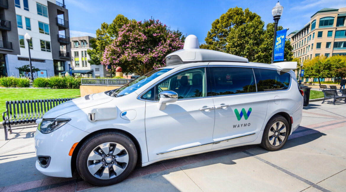 Image of a while self-driving Waymo SUV parked on a sunny day in Sunnyvale California