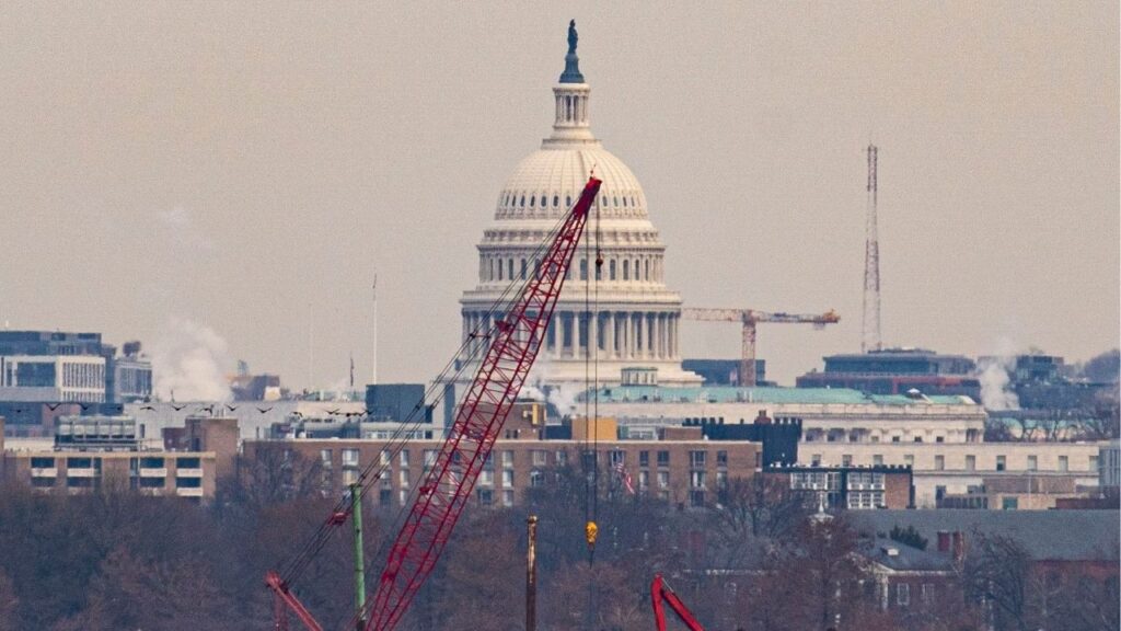 With the Capitol Building in the background, a crane lifts an engine from the wreckage of an American Airlines plane that crashed after a collision with a Black Hawk helicopter on the Potomac River in Arlington, Va., Feb. 3, 2025. The U.S. military admitted liability in a deadly air collision in the skies above the nation’s capital that killed 67 early this year, opening the door for the families of victims to seek damages for the crash, according to court documents. (Al Drago/The New York Times)