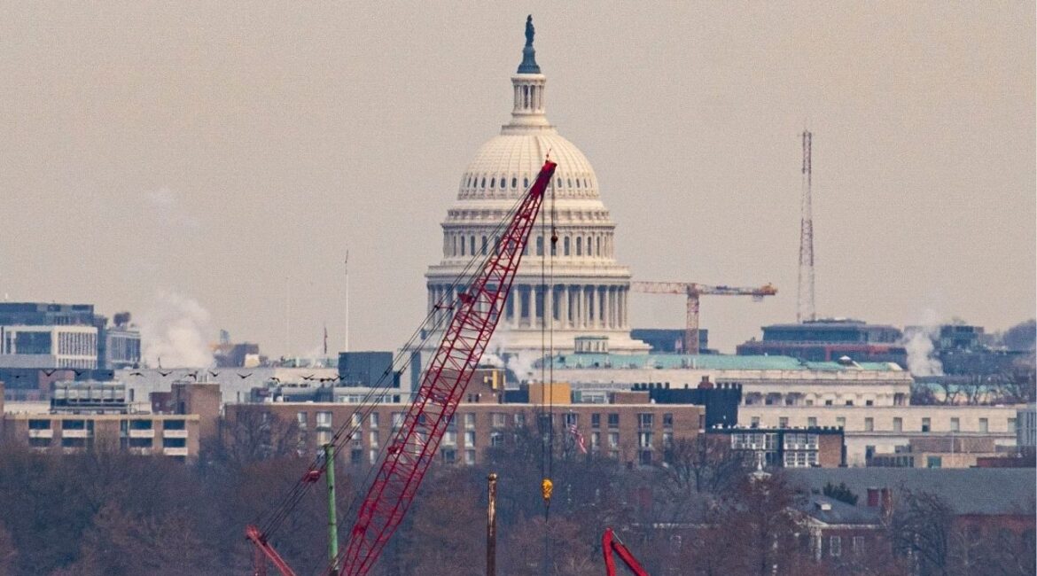 With the Capitol Building in the background, a crane lifts an engine from the wreckage of an American Airlines plane that crashed after a collision with a Black Hawk helicopter on the Potomac River in Arlington, Va., Feb. 3, 2025. The U.S. military admitted liability in a deadly air collision in the skies above the nation’s capital that killed 67 early this year, opening the door for the families of victims to seek damages for the crash, according to court documents. (Al Drago/The New York Times)
