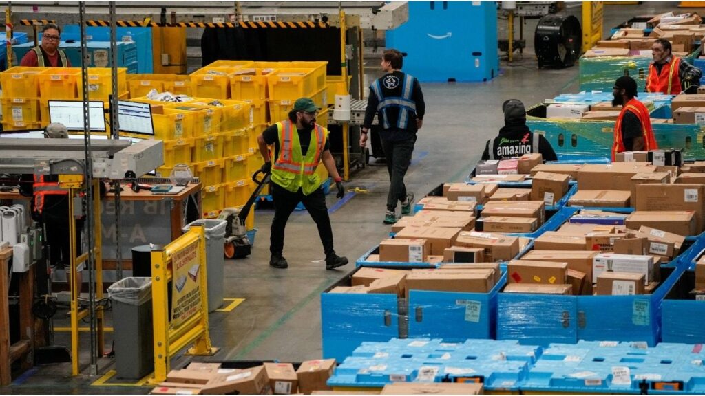 Workers move products during Cyber Monday at Amazon's fulfilment center in Robbinsville, New Jersey, U.S., December 1, 2025. (Reuters/Eduardo Munoz)