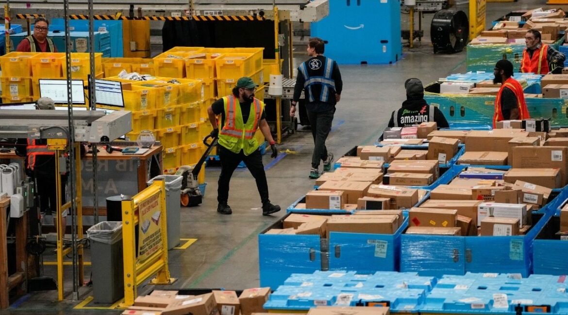 Workers move products during Cyber Monday at Amazon's fulfilment center in Robbinsville, New Jersey, U.S., December 1, 2025. (Reuters/Eduardo Munoz)