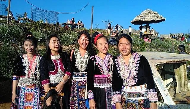 mage of Bouasvanh Lor with Hmong women wearing traditional regalia.
