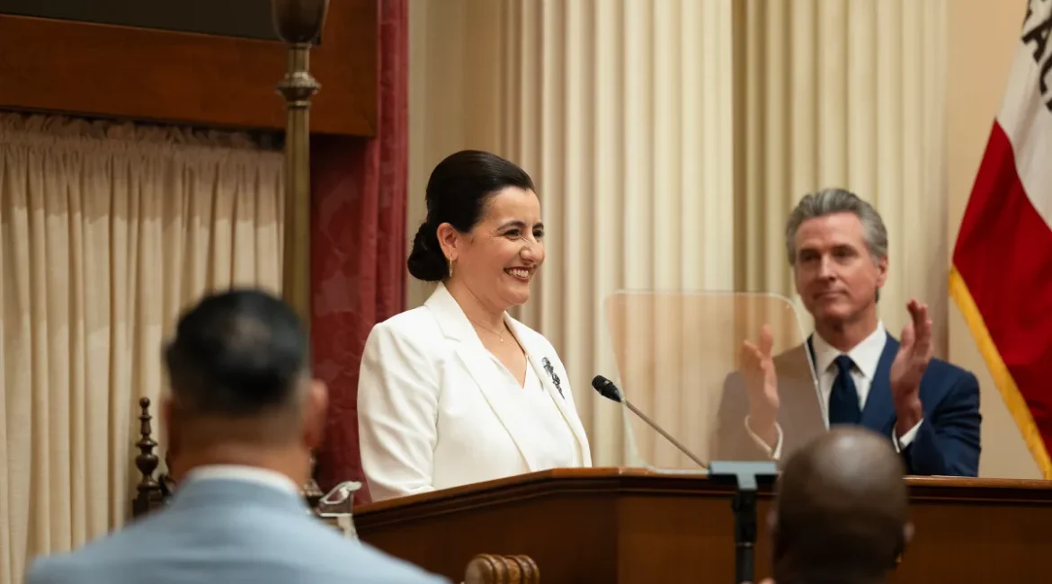 Image of a smiling Monique Limón being sworn in as California Senate leader while Gov. Gavin Newsom applauds.