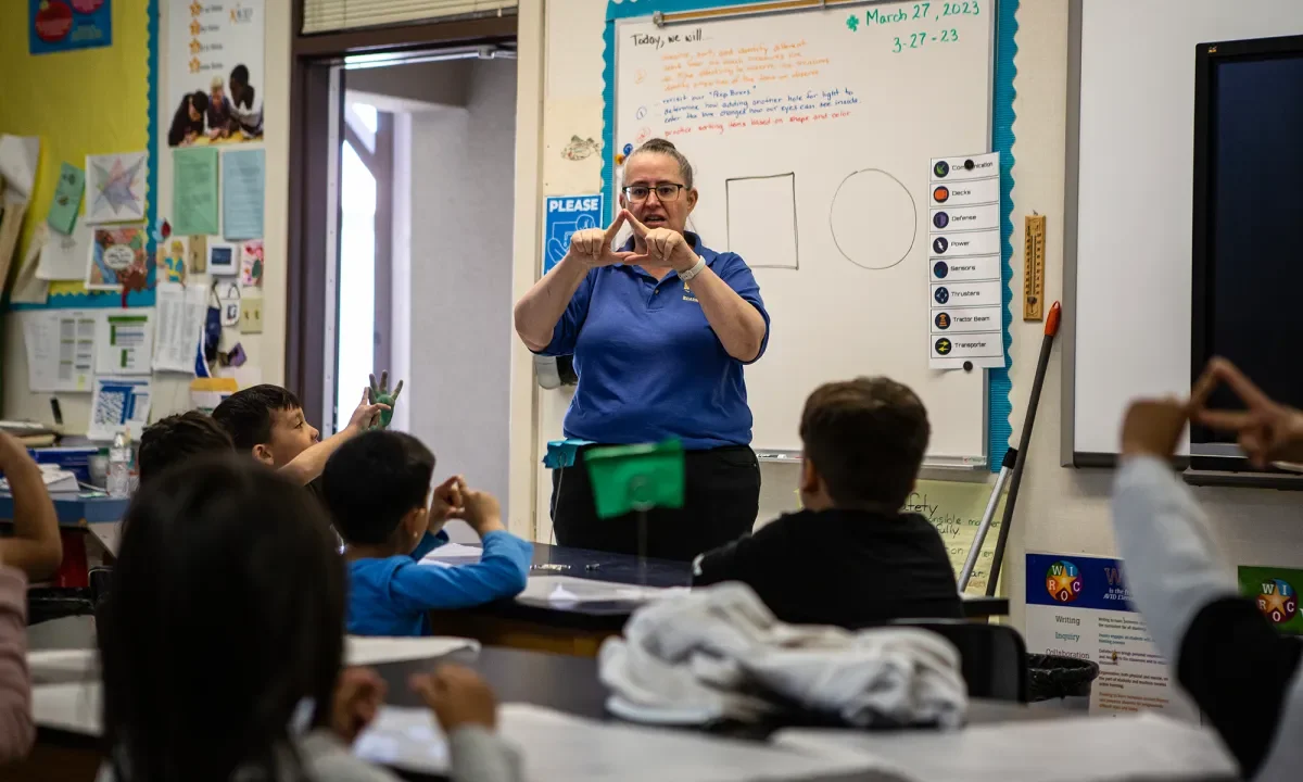 Image of a kindergarten teacher teaching shapes to her students