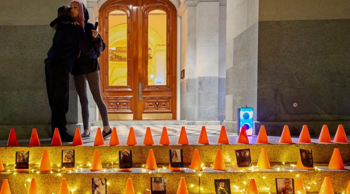 Image of two women hugging at a candlelight vigil in memory of people killed by drunk drivers