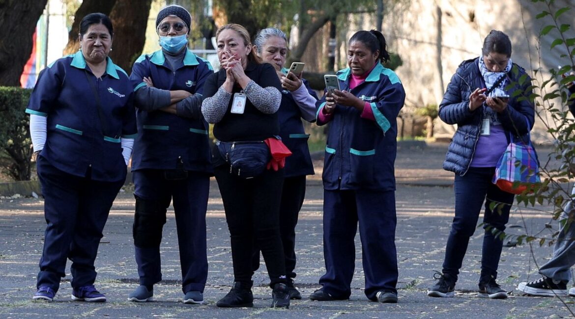Image of people standing outside on the sidewalk following an earthquake in Mexico City