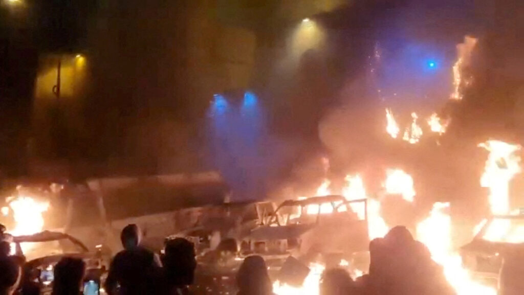 Protesters gather as vehicles burn, amid evolving anti-government unrest, in Tehran, Iran, in this screen grab obtained from a social media video released on January 9, 2026. Social Media/via Reuters/File Photo