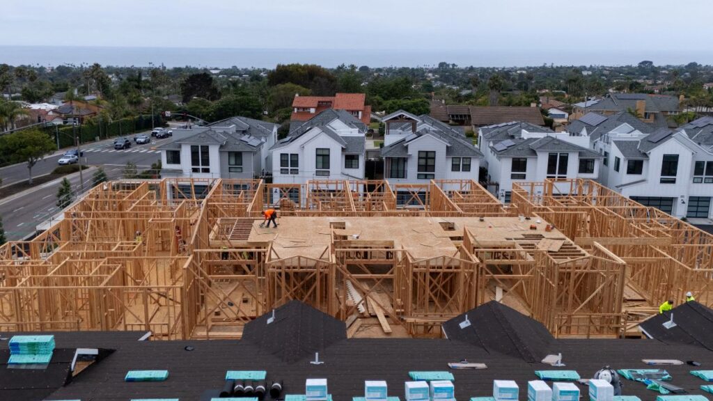 A drone view shows construction personnel working on a multi-home residential project by Shea Homes in Encinitas, California, U.S. July 21, 2025. (Reuters/Mike Blake/File Photo)
