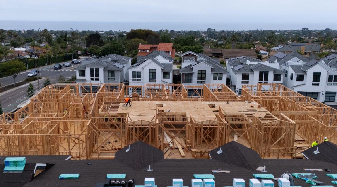 A drone view shows construction personnel working on a multi-home residential project by Shea Homes in Encinitas, California, U.S. July 21, 2025. (Reuters/Mike Blake/File Photo)