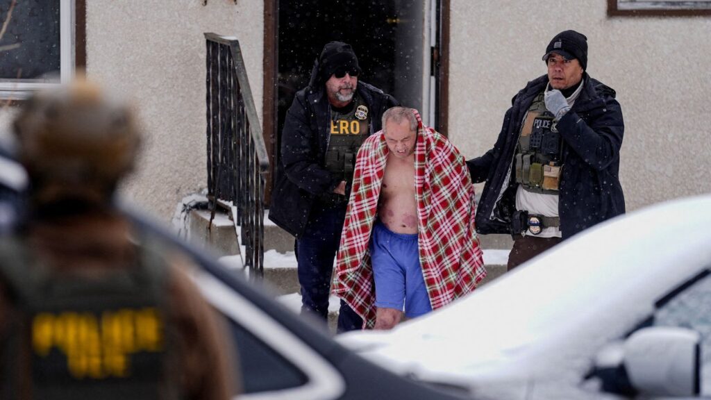 A man, whose family requested a Hmong interpreter, is detained after ICE agents and other law enforcement officers conducted an immigration raid at his home, days after an ICE agent fatally shot Renee Nicole Good, in St. Paul, Minnesota, U.S., January 18, 2026. (Reuters/Leah Millis)