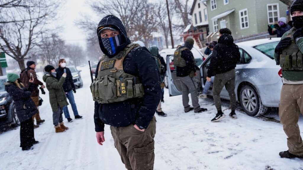 A member of the Enforcement and Removal Operations of ICE stands guard while a man is detained by Immigration and Customs Enforcement (ICE) agents during an immigration raid, days after an ICE agent fatally shot Renee Nicole Good, in Minneapolis, Minnesota, U.S., January 18, 2026. REUTERS/Leah Millis