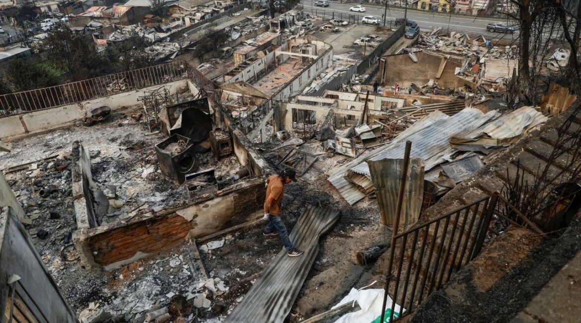 A person inspects a destroyed building, in the aftermath of a forest fire in the Biobio region, where multiple wildfires prompted emergency evacuations, in Concepcion, Chile January 19, 2026. (Reuters/Juan Gonzalez)