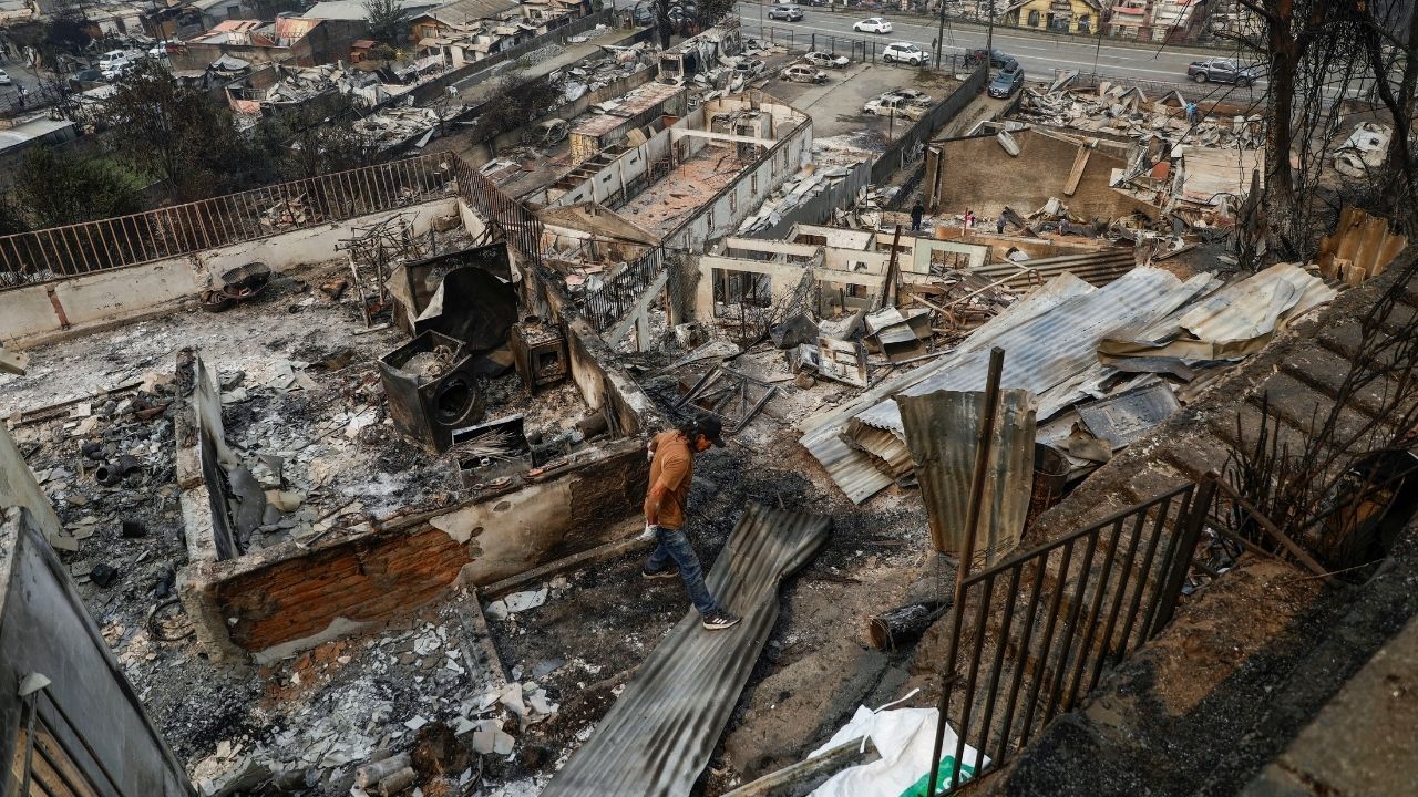 A person inspects a destroyed building, in the aftermath of a forest fire in the Biobio region, where multiple wildfires prompted emergency evacuations, in Concepcion, Chile January 19, 2026. (Reuters/Juan Gonzalez)