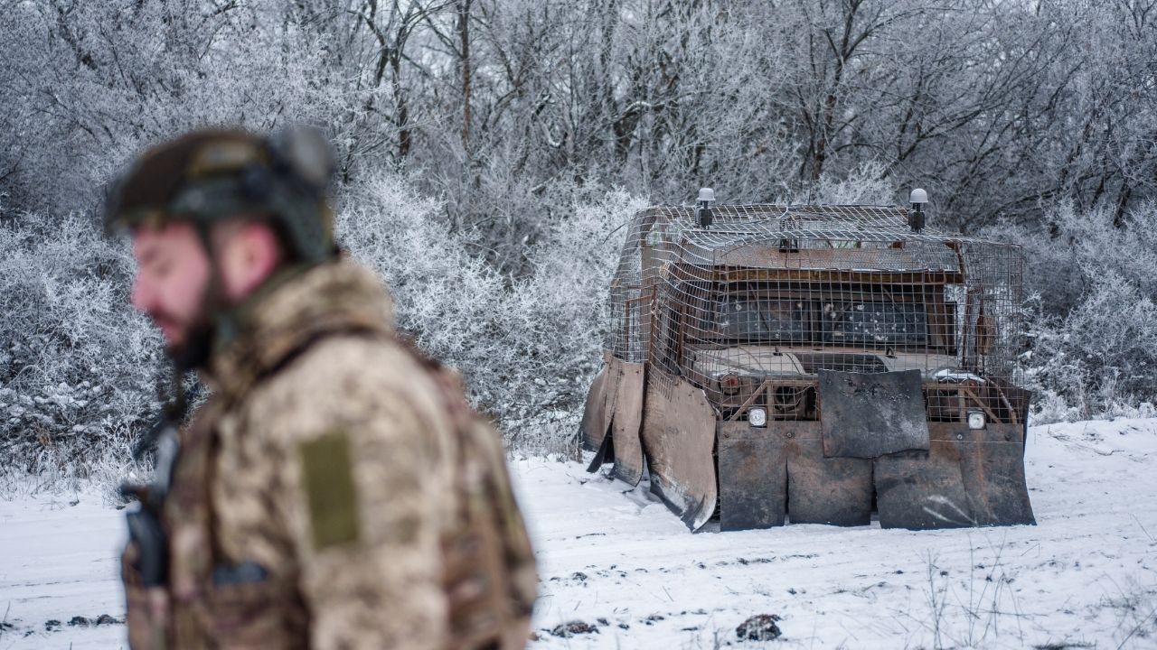 A serviceman of the 28th Separate Mechanized Brigade of the Ukrainian Armed Forces walks next to a Humvee covered with a makeshift anti-drone protection at a training ground near a front line, amid Russia's attack on Ukraine, in Donetsk region, Ukraine January 22, 2026. (Reuters/Serhii Korovainyi)