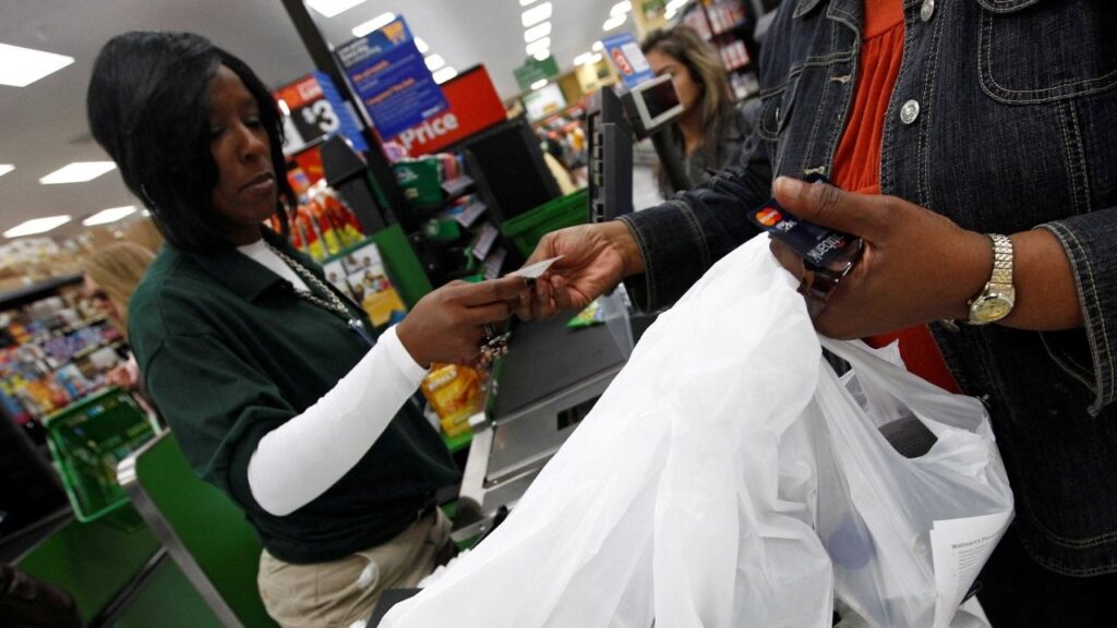 A shopper pays for her purchases in a Walmart Neighborhood Market in Chicago, September 21, 2011. (Reuters File)