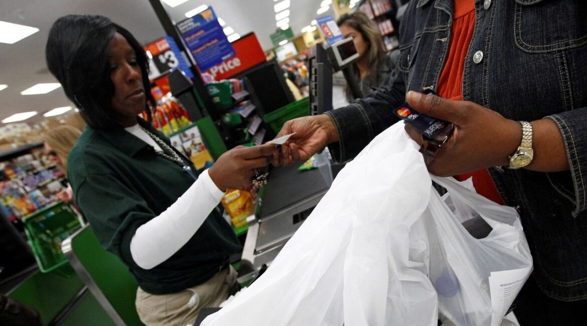 A shopper pays for her purchases in a Walmart Neighborhood Market in Chicago, September 21, 2011. (Reuters File)