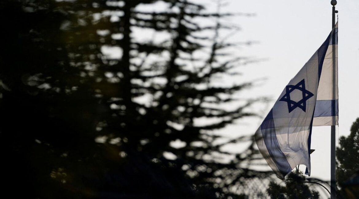 An Israeli flag flies outside the Prime Minister's Office in Jerusalem, October 22, 2024. (Reuters/Nathan Howard/Pool)