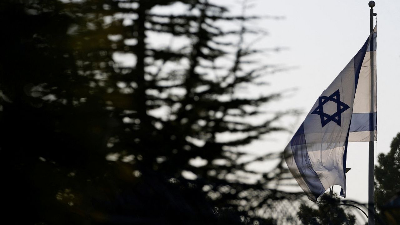 An Israeli flag flies outside the Prime Minister's Office in Jerusalem, October 22, 2024. (Reuters/Nathan Howard/Pool)