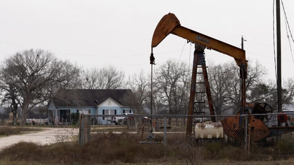 An oil pumpjack in front of a house in Ganado, Texas, U.S., January 8, 2026. (Reuters/Antranik Tavitian)