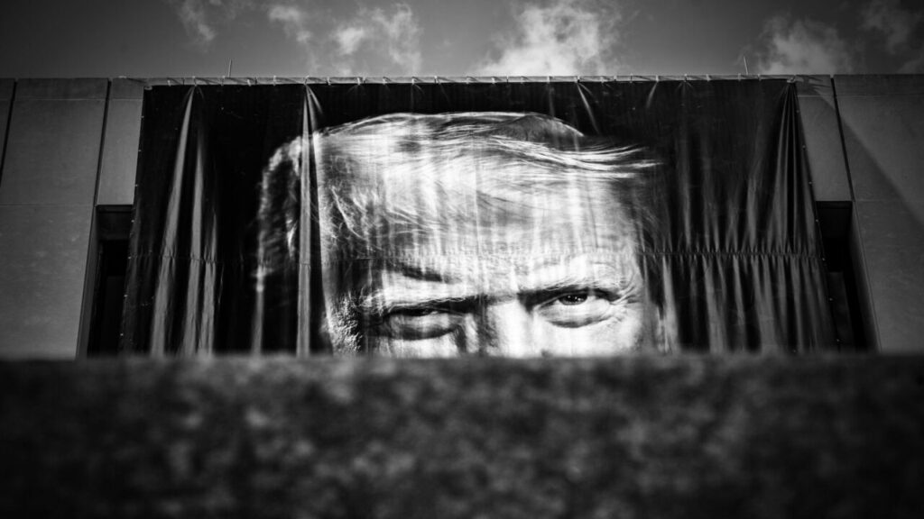 Black and white image of President Donald Trump hung over the front facade of the Department of Labor building