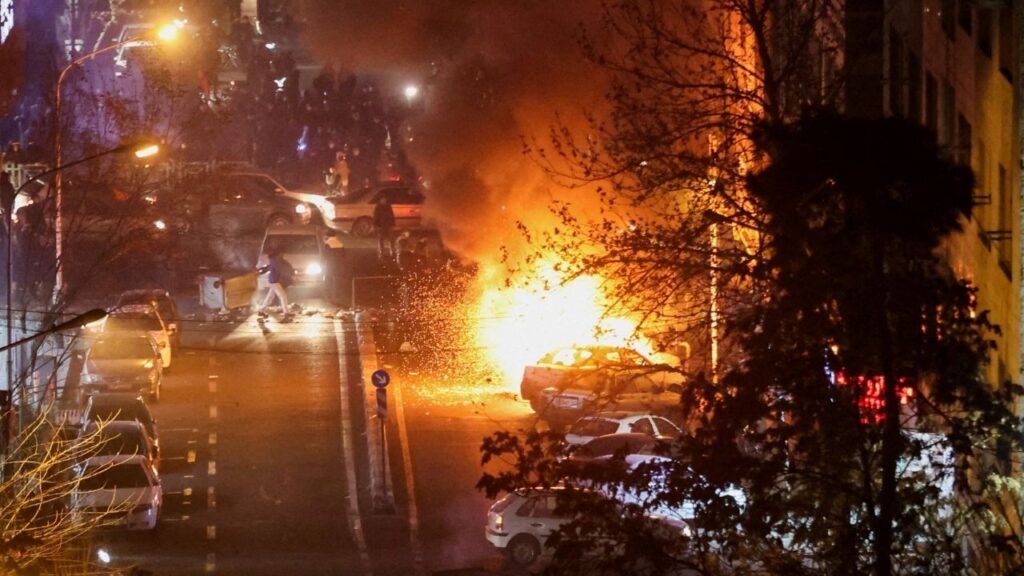 Cars burn in a street during a protest over the collapse of the currency's value, in Tehran, Iran, January 8, 2026. (Stringer/WANA (West Asia News Agency) via Reuters)