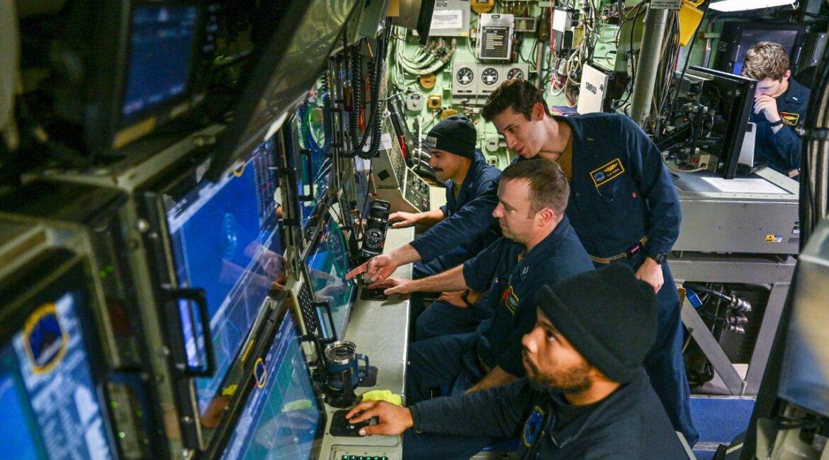 Crew abroad the USS Hampton at work during a deployment under the Arctic Ocean on March 17, 2024. The use of gunboats diplomacy faded heavily after World War II, but the practice of using navel force to bring an adversary to heel is as old as civilization itself. (Kenny Holston / The New York Times)