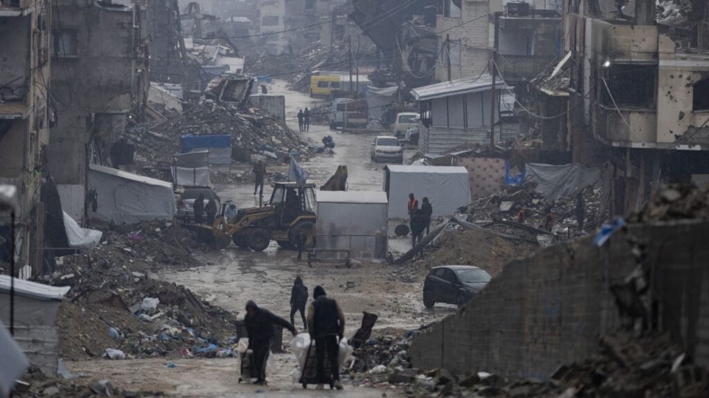 Destroyed buildings on a wet day in Gaza City, Dec. 11, 2025. When President Trump said he planned to establish and lead a “Board of Peace” to oversee the cease-fire between Israel and Hamas in Gaza, many did not know what to make of it. (Saher Alghorra/The New York Times)