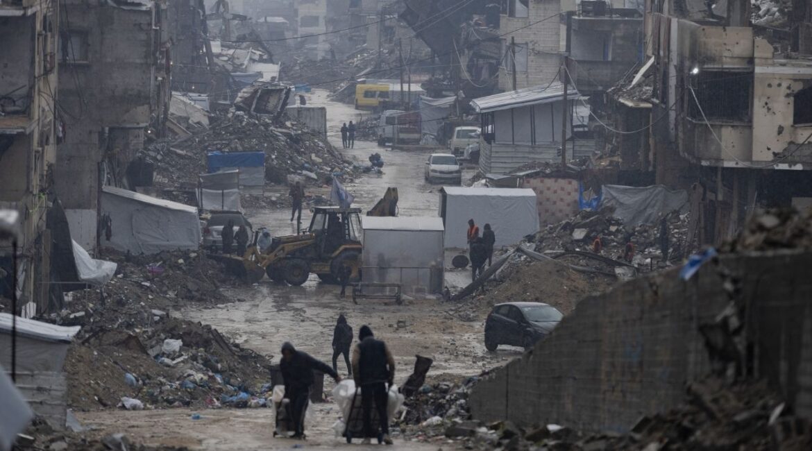 Destroyed buildings on a wet day in Gaza City, Dec. 11, 2025. When President Trump said he planned to establish and lead a “Board of Peace” to oversee the cease-fire between Israel and Hamas in Gaza, many did not know what to make of it. (Saher Alghorra/The New York Times)