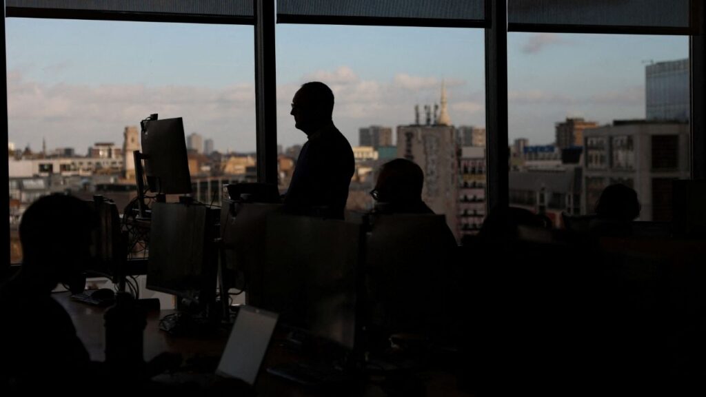 Employees work on computers in an office in London, Britain, November 13, 2025. (Reuters/Hannah McKay)