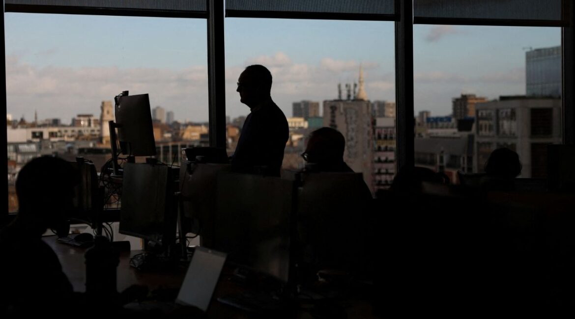 Employees work on computers in an office in London, Britain, November 13, 2025. (Reuters/Hannah McKay)