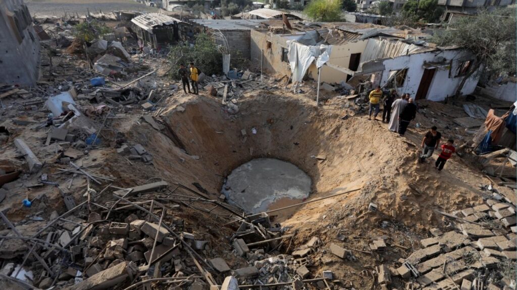 FILE — People gather around a bomb crater left by an Israeli airstrike in Khan Younis in Gaza on Wednesday, Oct. 11, 2023. In April 2024, Congress approved more than $14 billion in emergency military assistance to Israel. (Yousef Masoud/The New York Times)