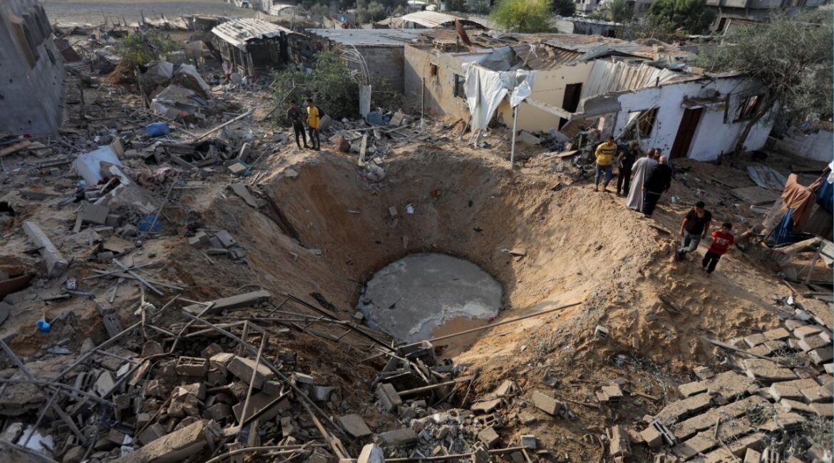 FILE — People gather around a bomb crater left by an Israeli airstrike in Khan Younis in Gaza on Wednesday, Oct. 11, 2023. In April 2024, Congress approved more than $14 billion in emergency military assistance to Israel. (Yousef Masoud/The New York Times)