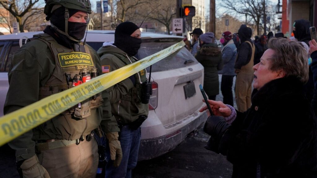 Federal agents stand behind police tape as people gather near the site where a man identified as Alex Pretti was fatally shot by federal agents trying to detain him, in Minneapolis, Minnesota, U.S., January 24, 2026. (Reuters File)