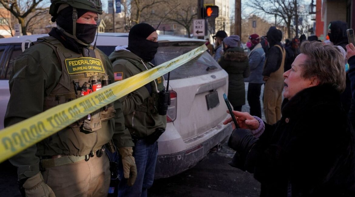 Federal agents stand behind police tape as people gather near the site where a man identified as Alex Pretti was fatally shot by federal agents trying to detain him, in Minneapolis, Minnesota, U.S., January 24, 2026. (Reuters File)