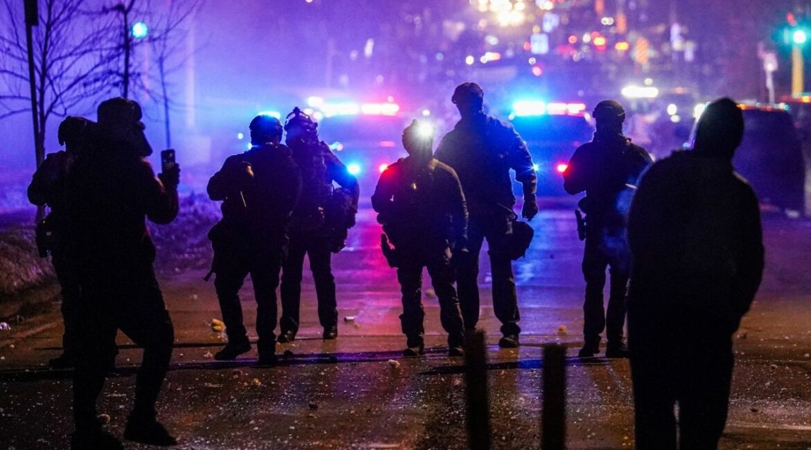 Federal agents stand guard after deploying tear gas as community members protest after federal law enforcement agents were involved in a shooting incident, a week after a U.S. Immigration and Customs Enforcement (ICE) agent fatally shot Renee Nicole Good, in Minneapolis, Minnesota, U.S., January 14, 2026. (Reuters/Ryan Murphy)